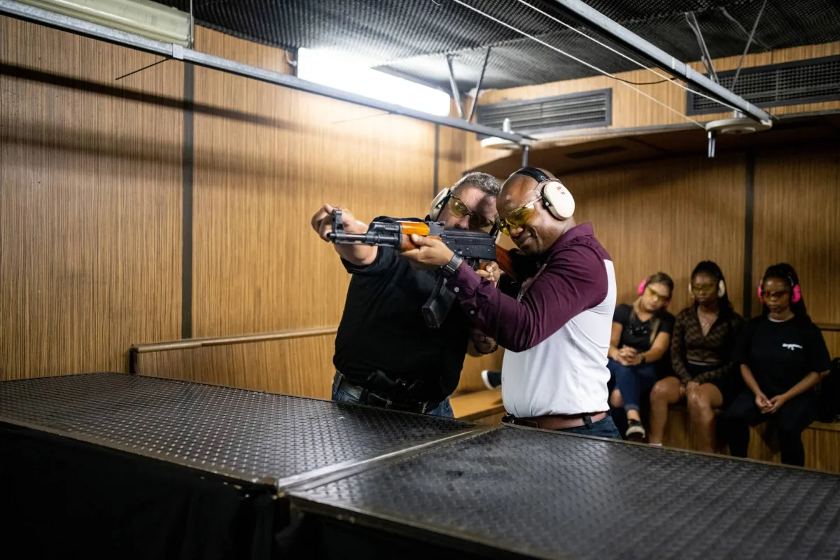 An instructor coaching a shooter on the Frontier range